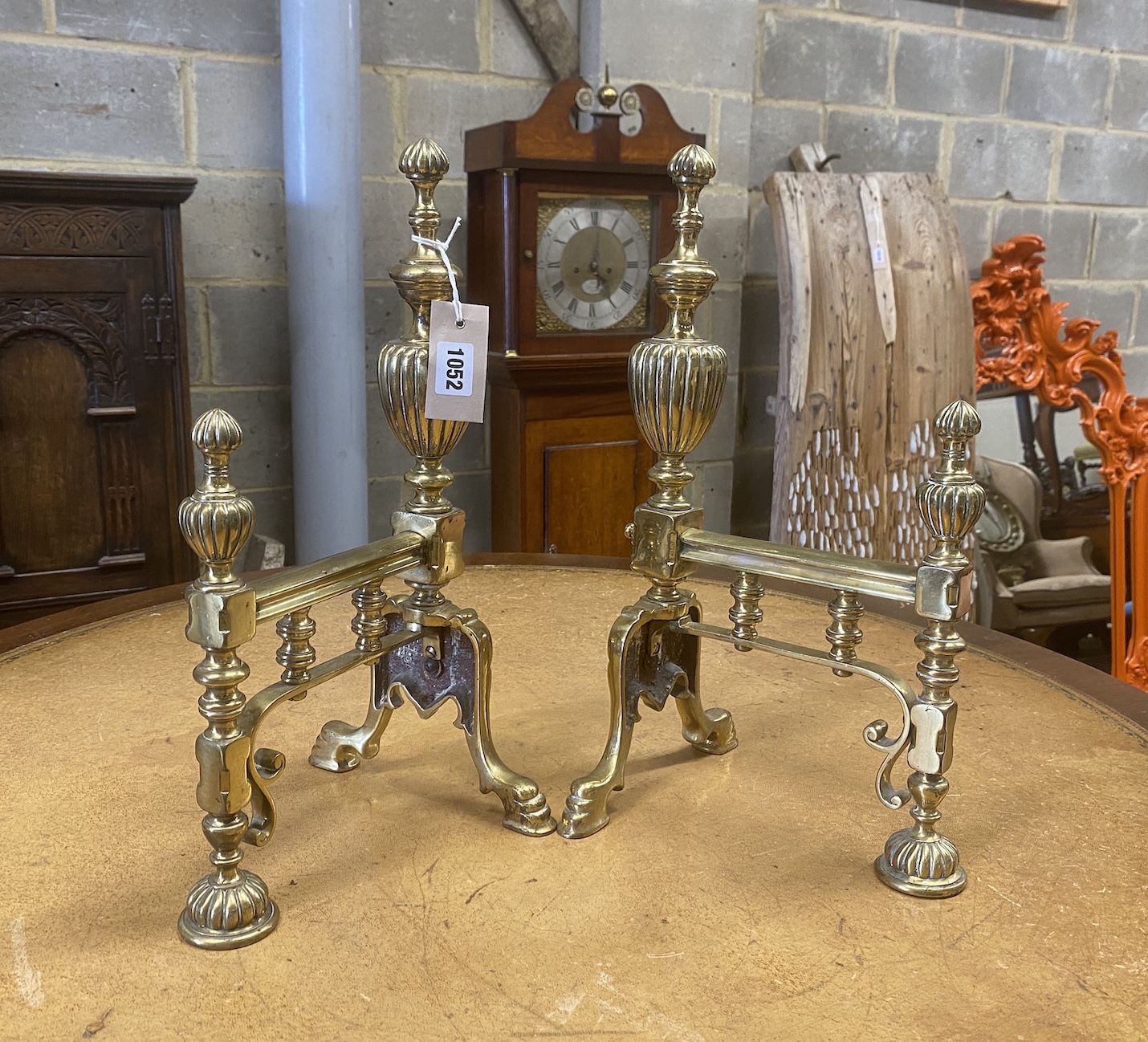 A pair of early 19th century brass fire dogs, height 42cm